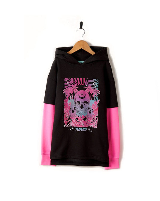 Mystic Skulls - Kids Pop Hoodie - Dark Grey by Saltrock, with pink sleeves and a skull illustration, made from a cotton/polyester blend, hanging on a wall.
