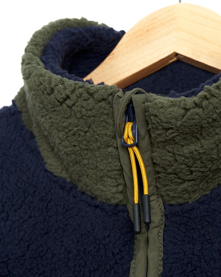A Saltrock Odin - Mens Zip Thru Fleece - Dark Blue jacket on a hanger.