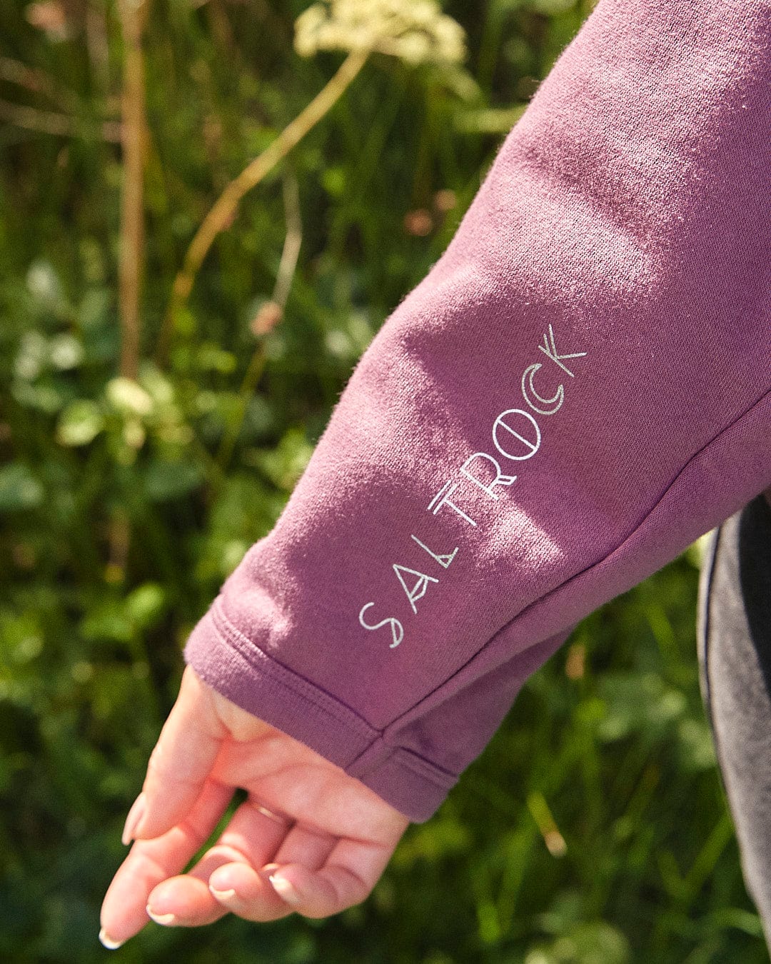 A woman wearing a Ophelia - Womens Pop Hoodie - Purple hoodie by Saltrock.