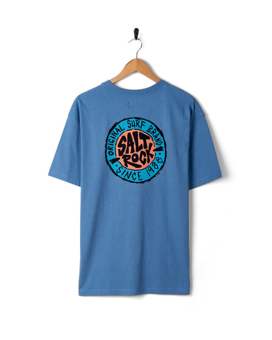 SR Original - Mens Short Sleeve T-Shirt in Blue from Saltrock, with a circular surf-themed graphic print, hanging on a white wall.
