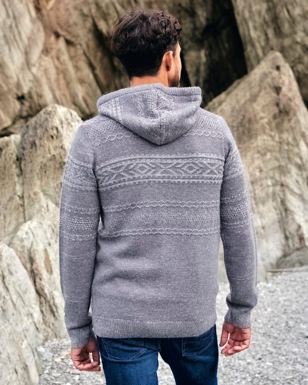 The back of a man wearing a comfortable grey hooded sweater featuring Saltrock Paxton Mens Knitted Hoodie.
