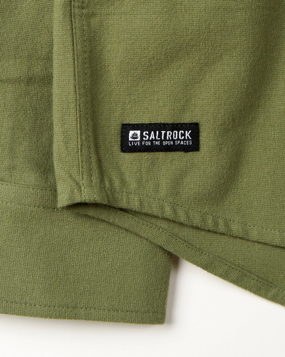 Close-up of a green, 100% cotton Penare - Mens Long Sleeve Shirt with a Saltrock brand label on a collared shirt.