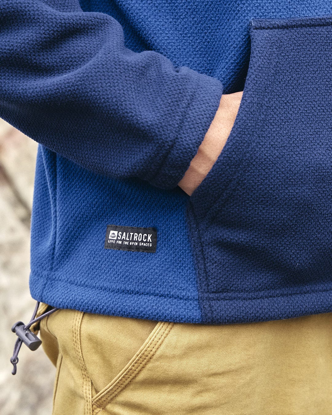 The back of a man wearing a blue Saltrock Peninsula - Mens 1/4 Zip Pullover Fleece hoodie in activewear style.