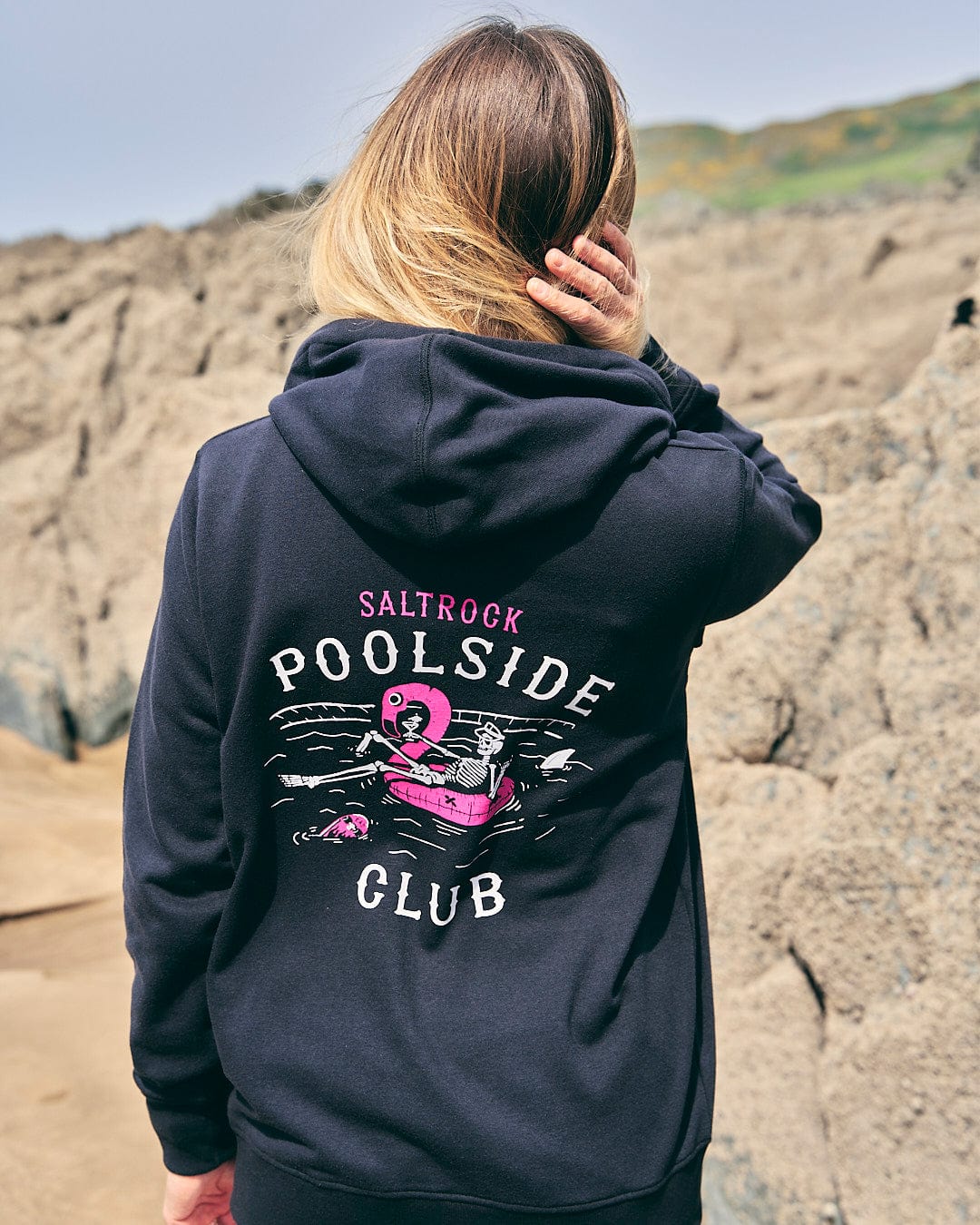 A woman wearing a Saltrock Lee-Ann - Womens Zip Hoodie - Black that says poolside club.