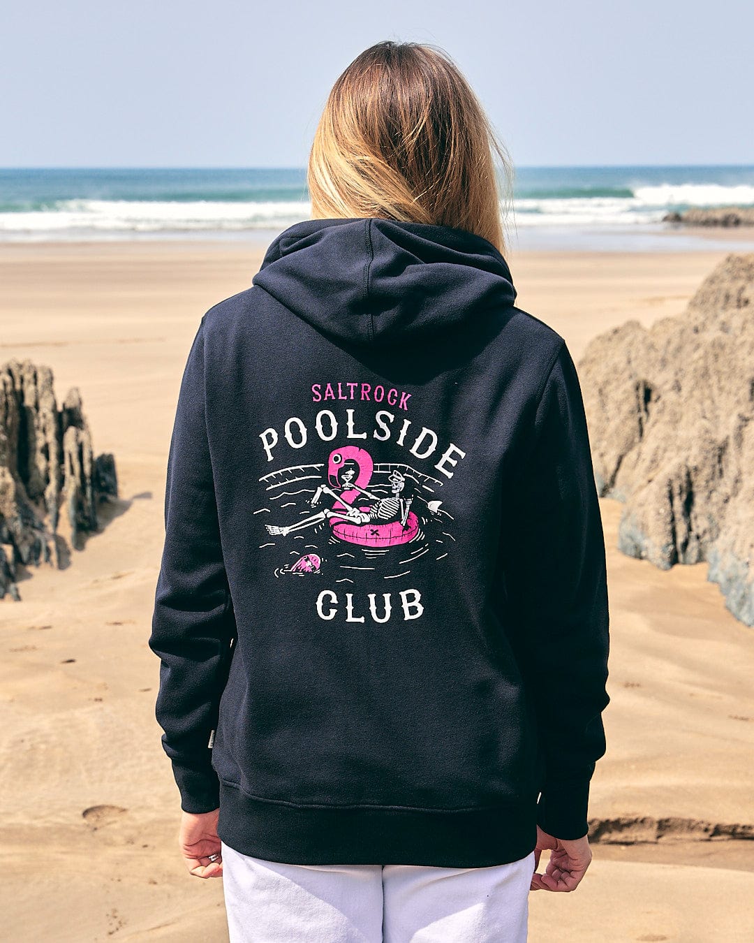 A woman wearing a black Lee-Ann - Womens Zip Hoodie - Black with the brand name Saltrock on it.