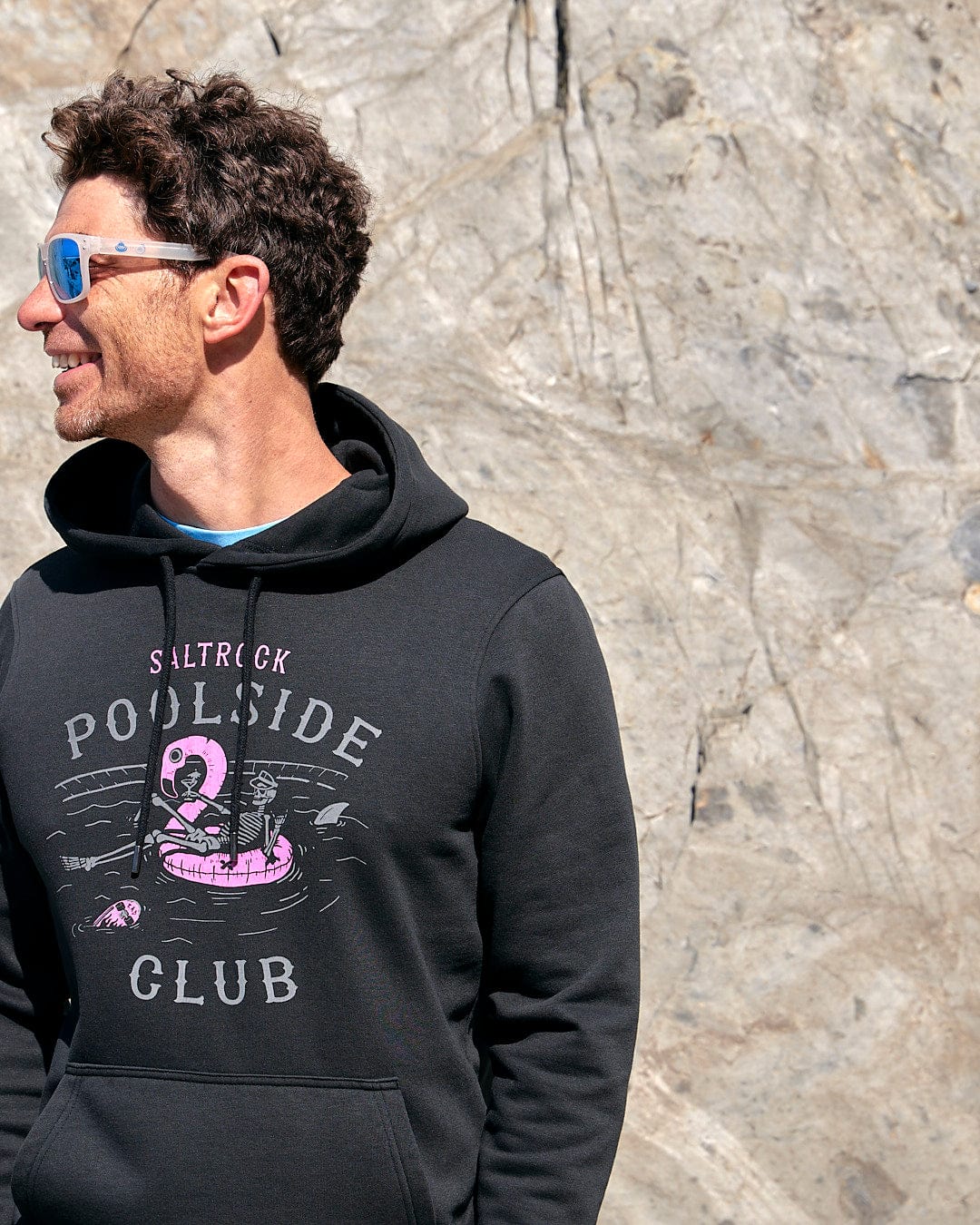 A man wearing a Poolside - Mens Pop Hoodie in black, by Saltrock.