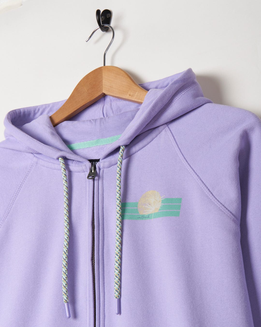 A Lilac Saltrock hoodie with a green stripe on it.