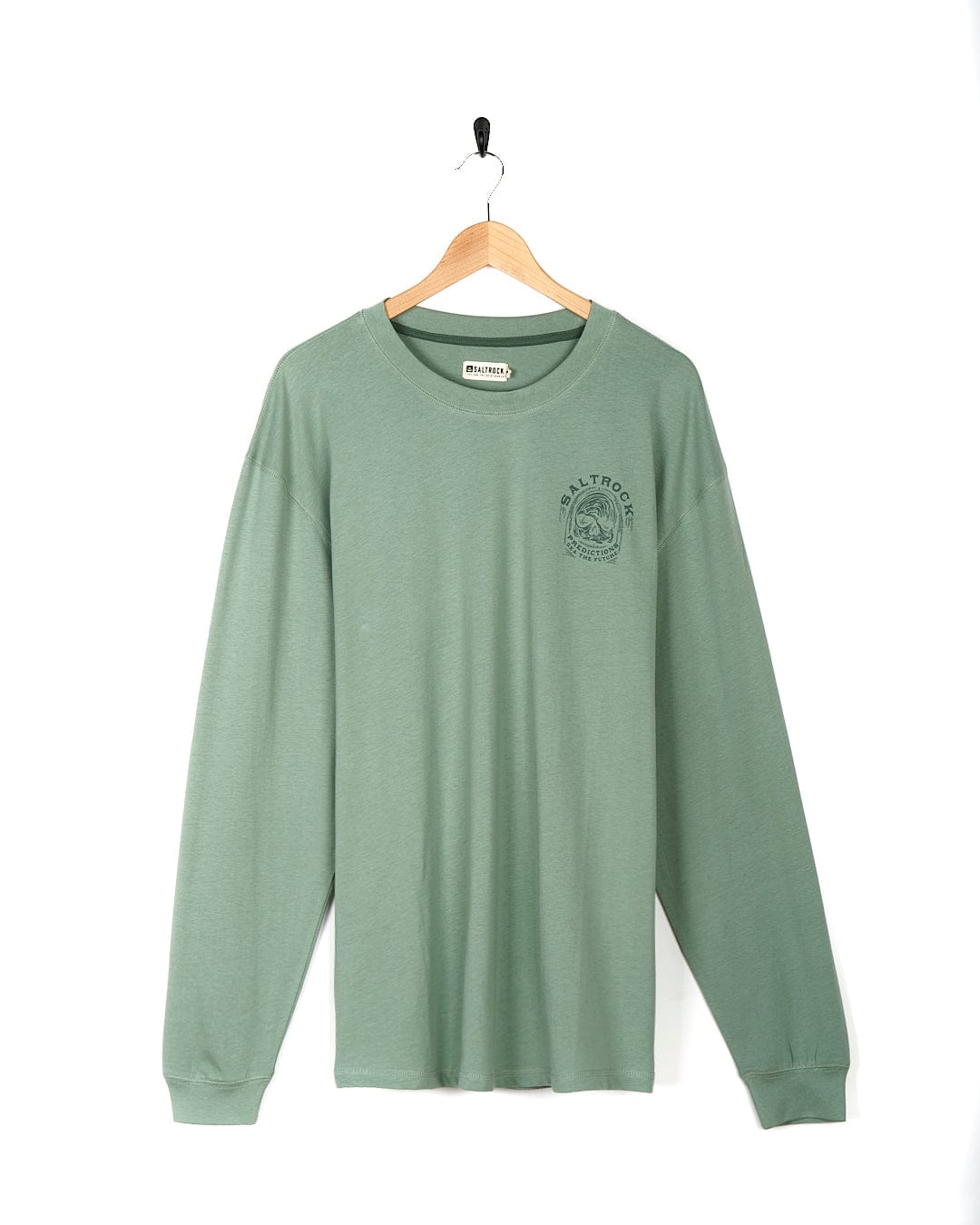 A Saltrock - Predictions - Men's Long Sleeve T-Shirt - Light Green with skull graphics hanging on a wooden hanger.
