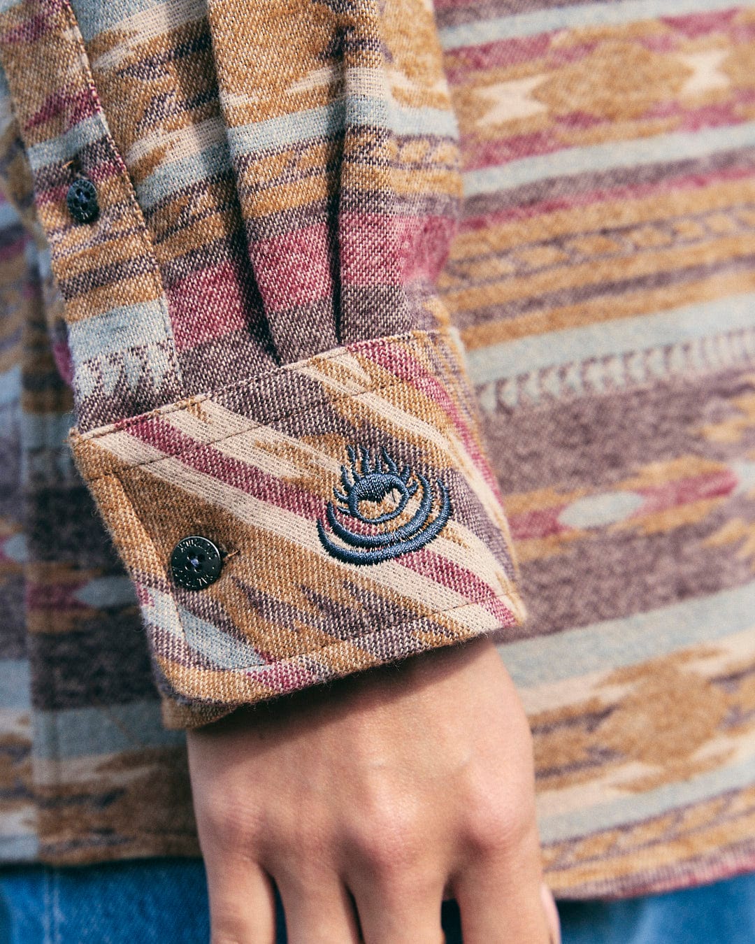 A man wearing a Saltrock Quinn - Womens Heavy Overshirt - Brown with an Aztec print pattern.