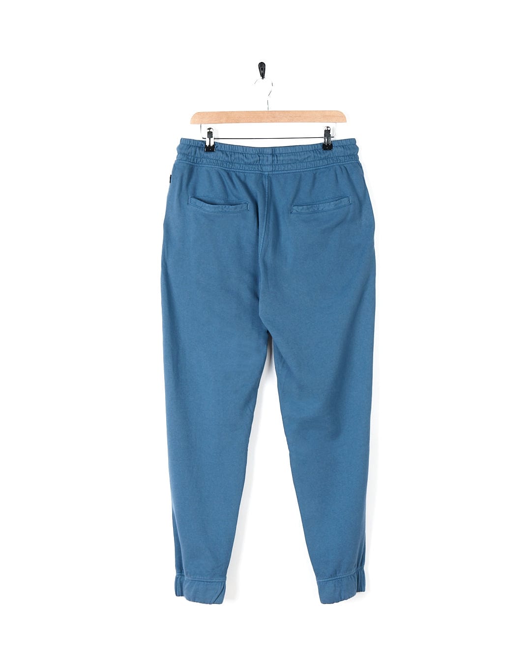 A stylish blue Ralfen jogger pants hanging on a hanger. Brand Name: Saltrock
