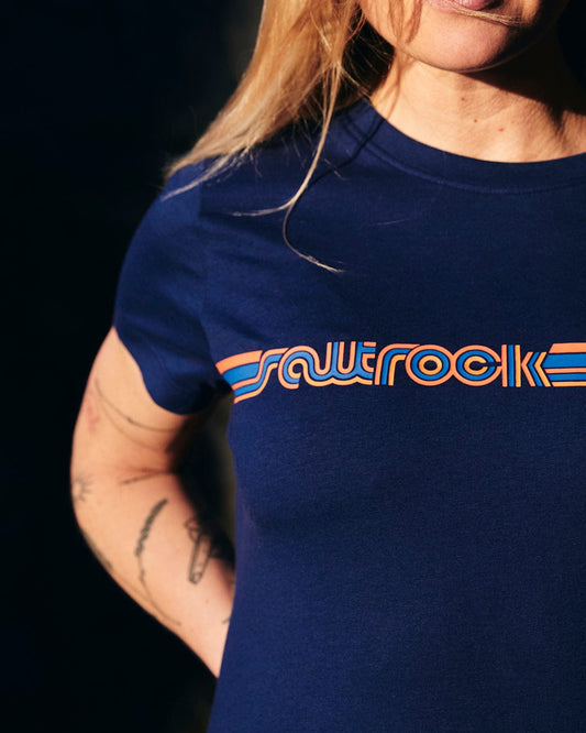 A woman wearing a classic Retro Ribbon - Womens Short Sleeve T-Shirt - Dark Blue with the word rawrockk on it.