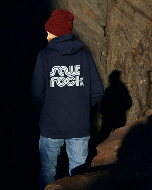 A woman wearing a Retro Wave Emb - Womens Zip Hoodie - Blue with Saltrock branding on the front pockets.