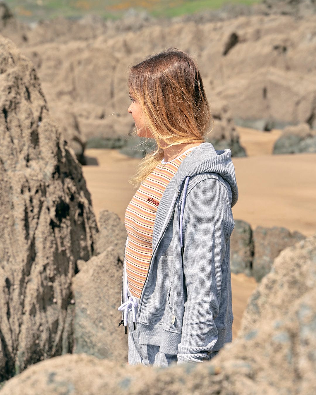 A woman wearing a Saltrock Rosalin - Womens Zip Hoodie - Light Grey.