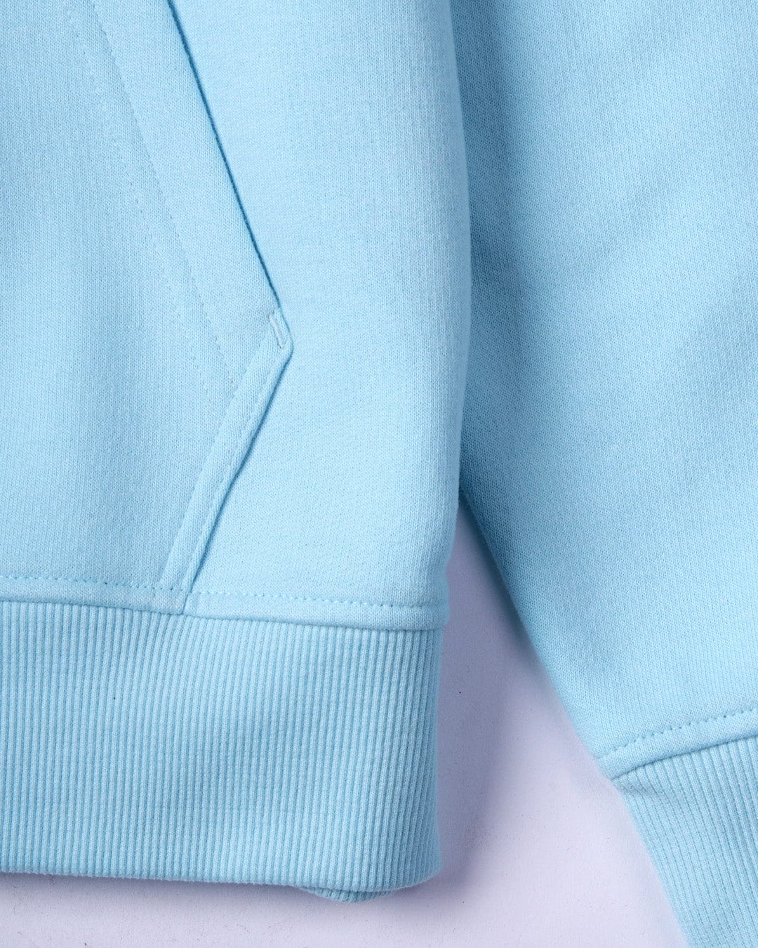 Close-up of a Saltrock Original - Mens Pop Hoodie in Light Blue jersey material with detailed stitching and ribbed cuffs.