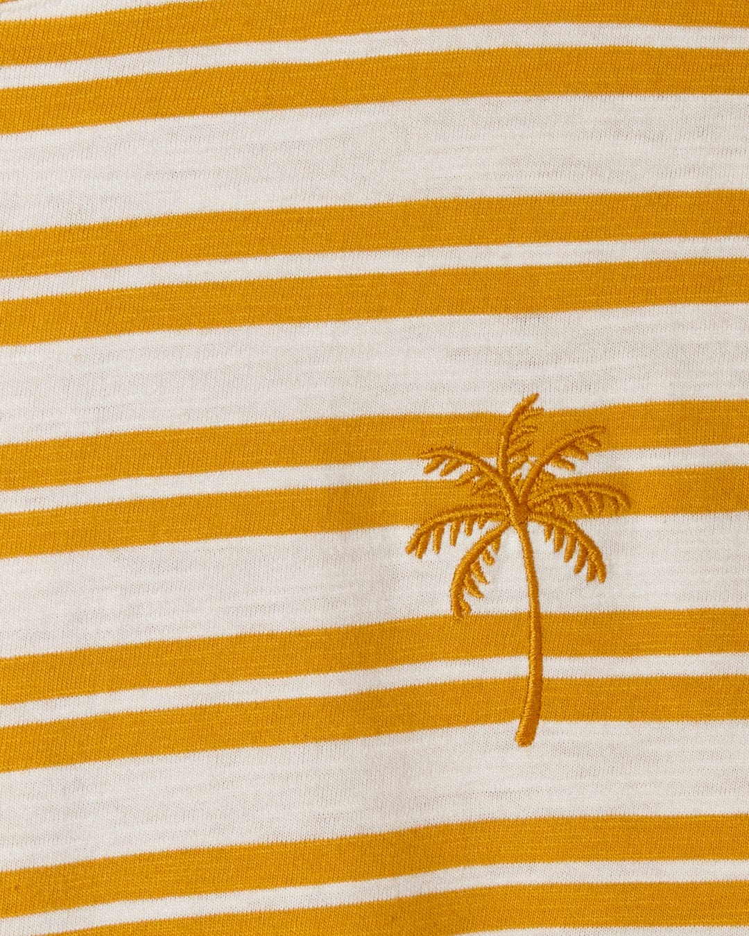 Close-up of a white and orange yarn dye stripe print fabric with an embroidered palm tree design in a contrasting orange thread on the Saltrock Sky - Womens Short Sleeve T-Shirt - Yellow.