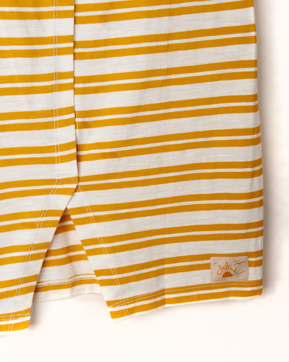 White fabric with yellow yarn dye stripe print and a small embroidered palm tree on the lower corner of the Saltrock Sky - Womens Short Sleeve T-Shirt - Yellow.