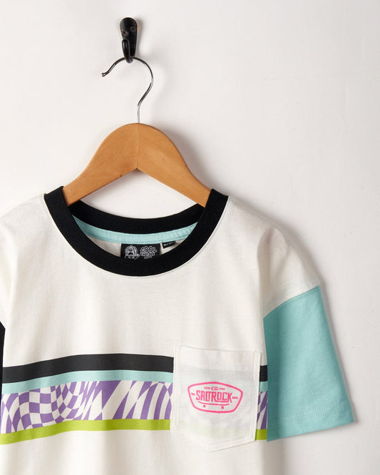 A colorful short-sleeved Soda - Recycled Kids Short Sleeve T-Shirt hanging on a wooden hanger against a white wall, featuring a colourblocked design in purple and teal by Saltrock.
