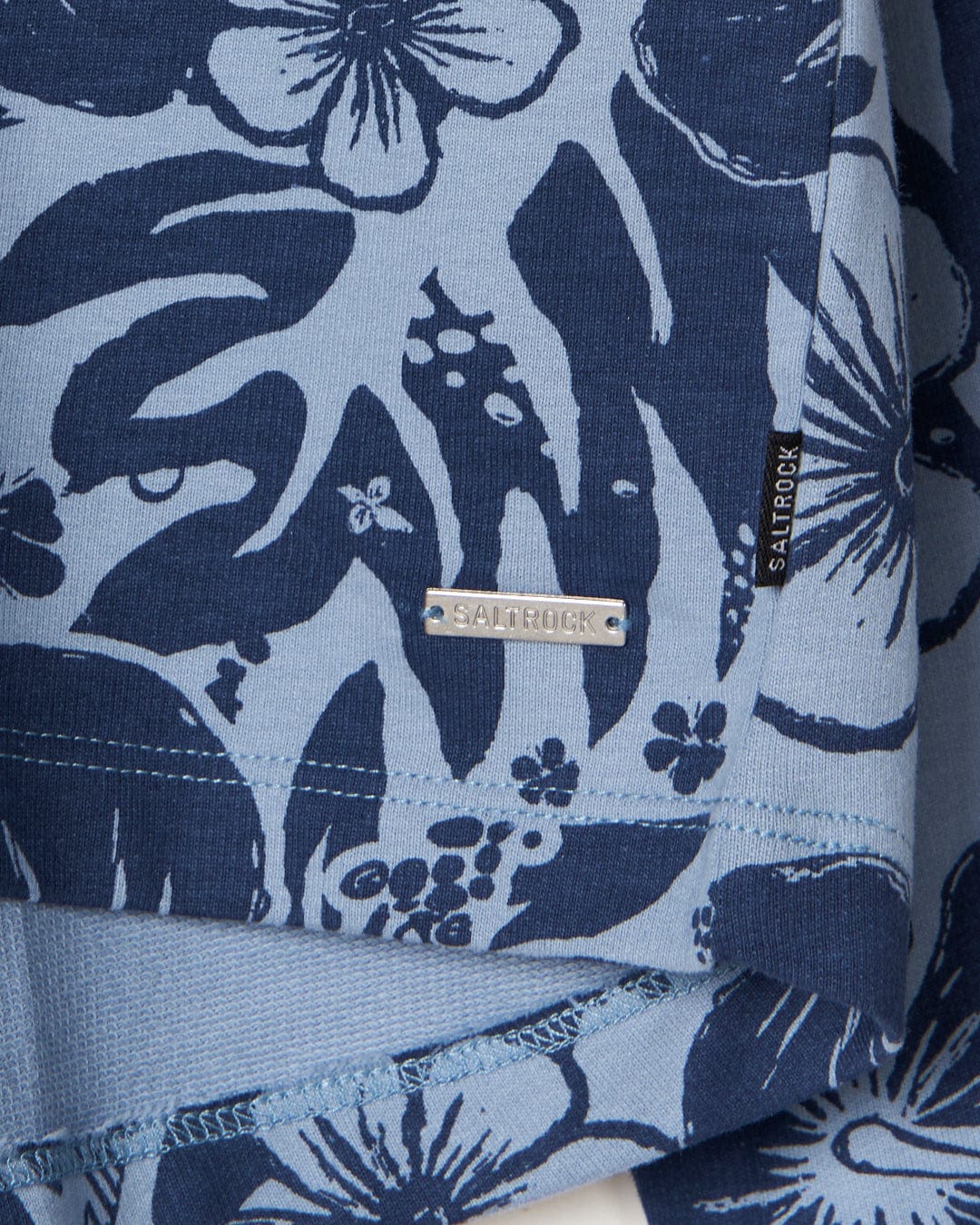 A blue Saltrock Soifra Hibiscus - Womens Pop Hood with hibiscus flowers on it.