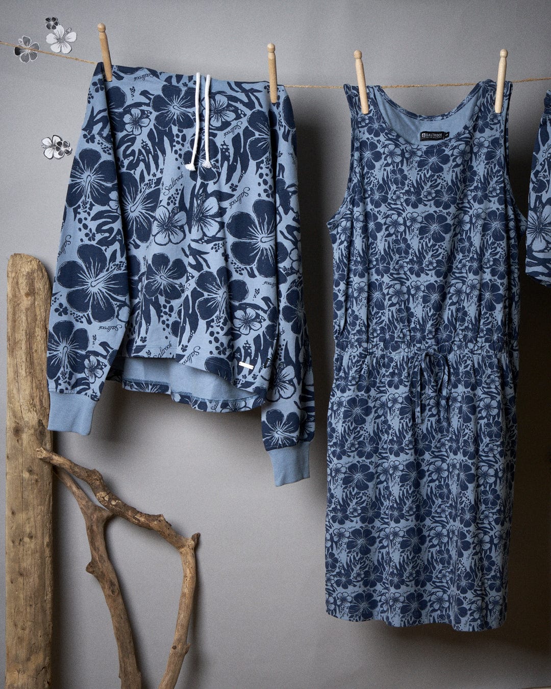 Clothes on a clothesline featuring Saltrock's Soifra Hibiscus - Womens Pop Hood - Blue patterns.