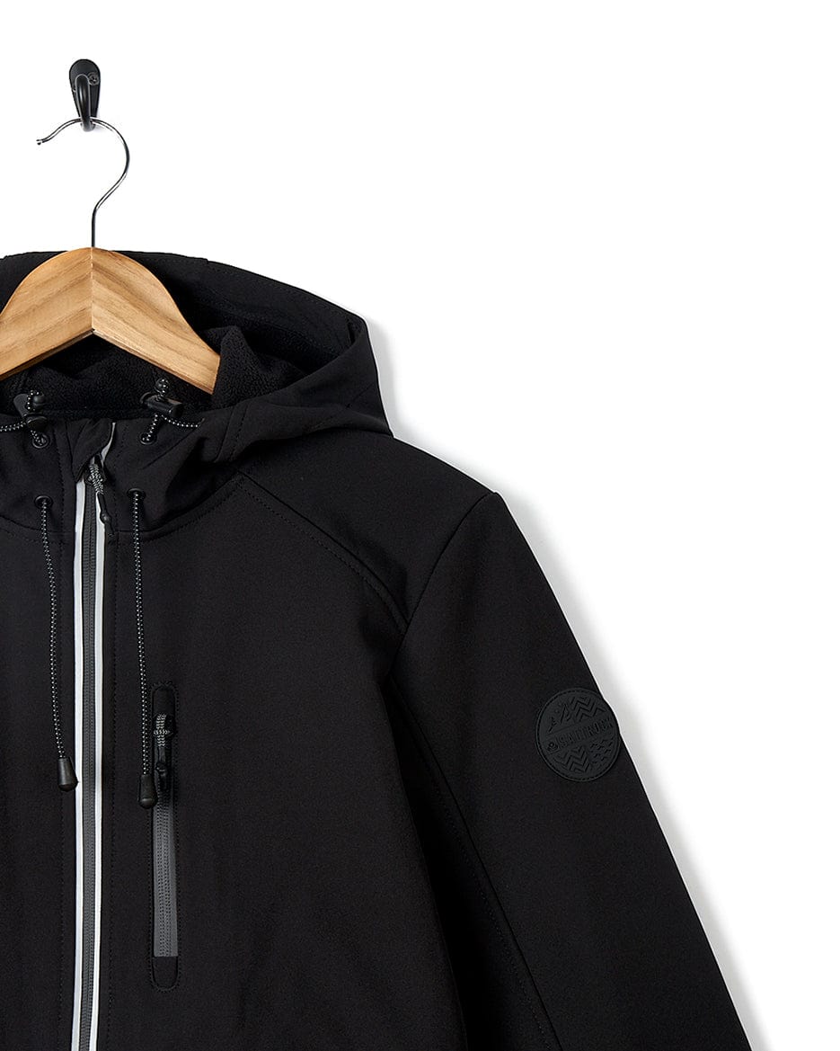 A Solae 2 - Womens Softshell Jacket - Black by Saltrock hanging on a hanger.