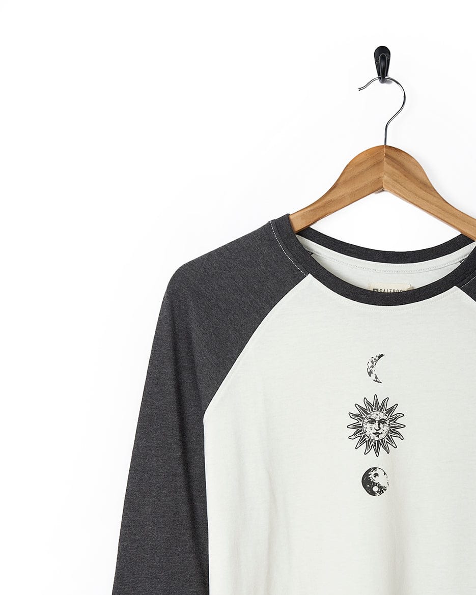A black and white Solstice - Womens Long Sleeve Raglan - Cream shirt with a sun and moon on it by Saltrock.