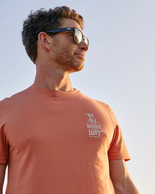 A man sporting Lost Ships - Mens Short Sleeve T-Shirt - Orange and Saltrock classic sunglasses.
