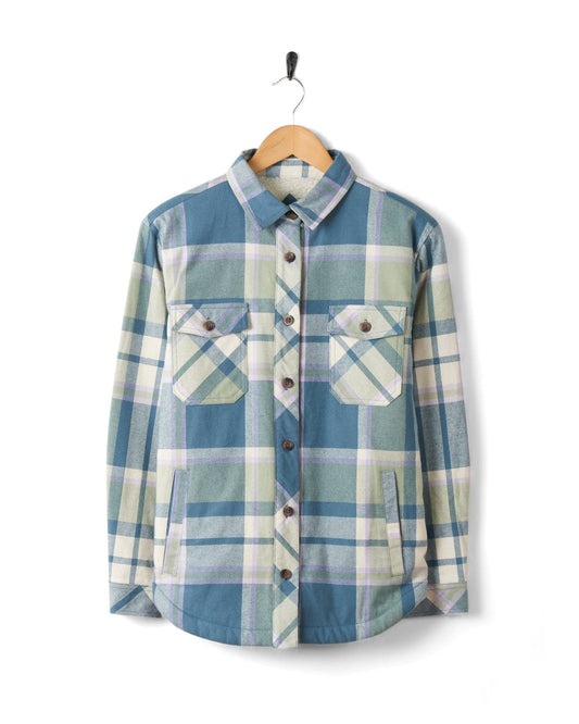 A Stella - Womens Borg Lined Long Sleeve Shirt in blue check print plaid hanging on a hanger.