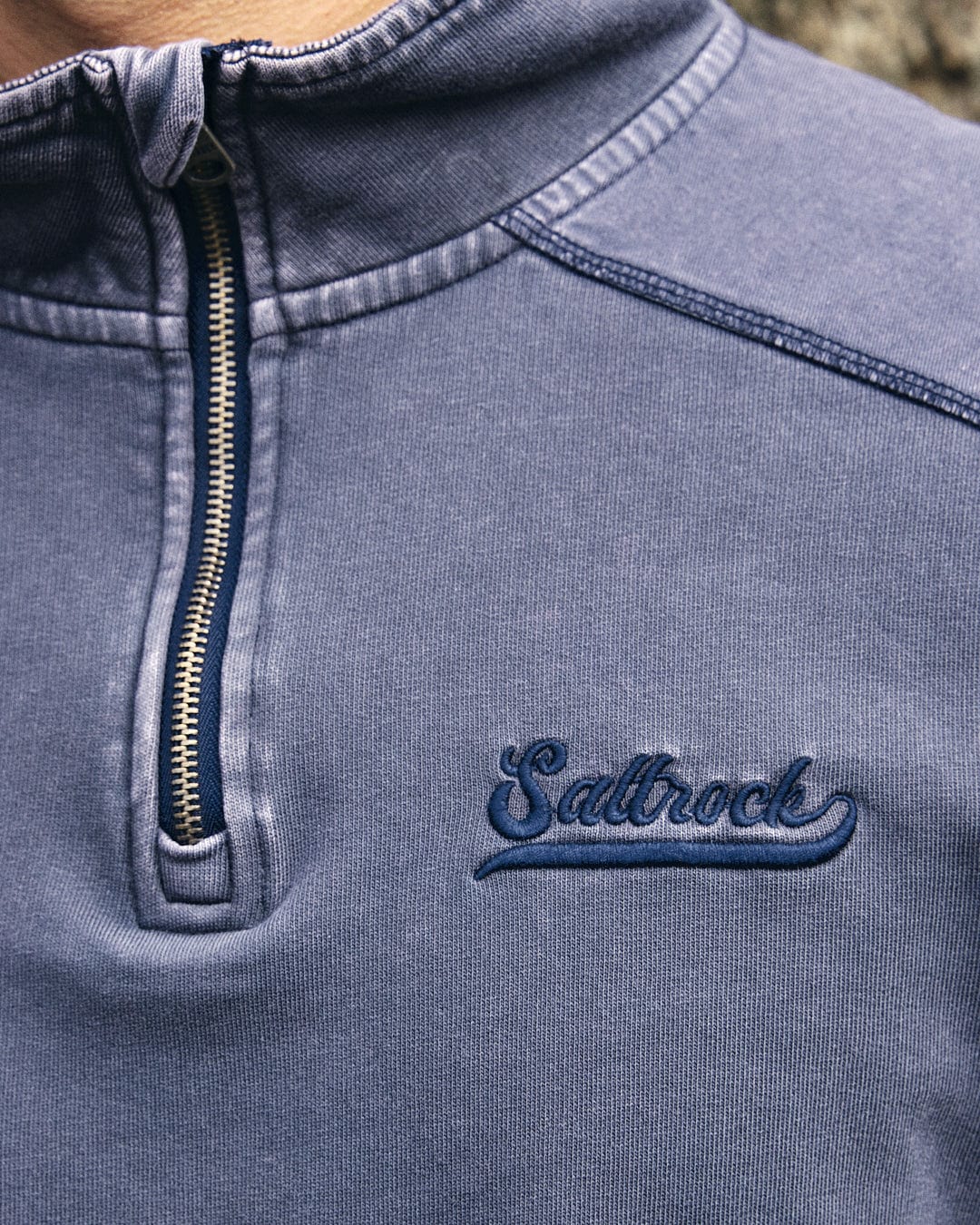 A fashion-forward man sporting a Stellan - Mens 1/4 Neck Sweat - Grey Acid Wash sweatshirt by Saltrock.