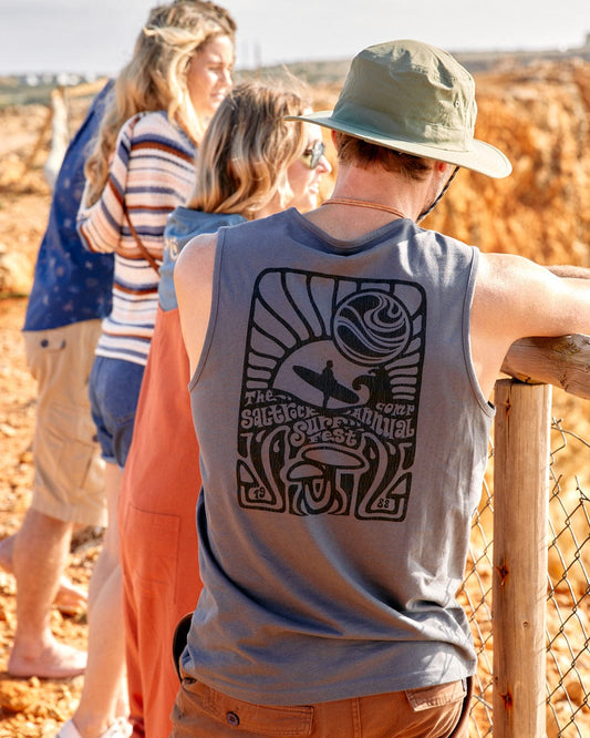A group of people standing on a railing looking at the ocean, one of them wearing a Saltrock Surf Fest - Mens Vest - Dark Grey.
