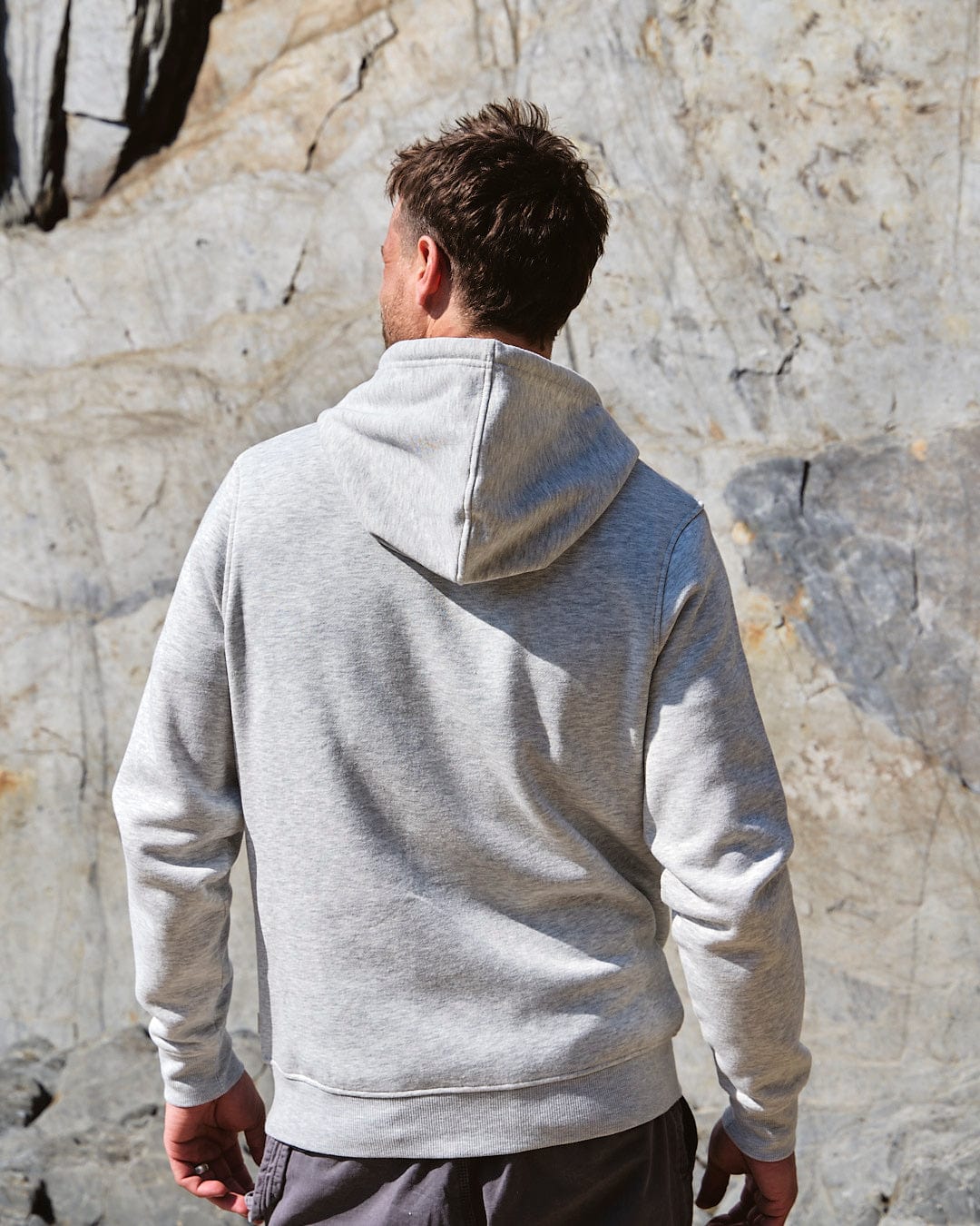 The back of a man wearing a grey Taped Stripe - Mens Zip Hoodie featuring Saltrock branding.