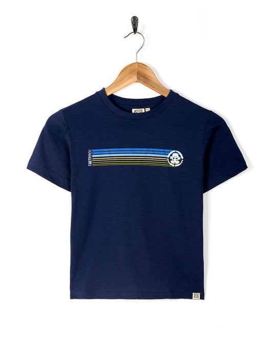 Navy blue kids tee with a horizontal retro striped pattern and circular Saltrock Tok graphic on the chest, displayed on a hanger against a white background.