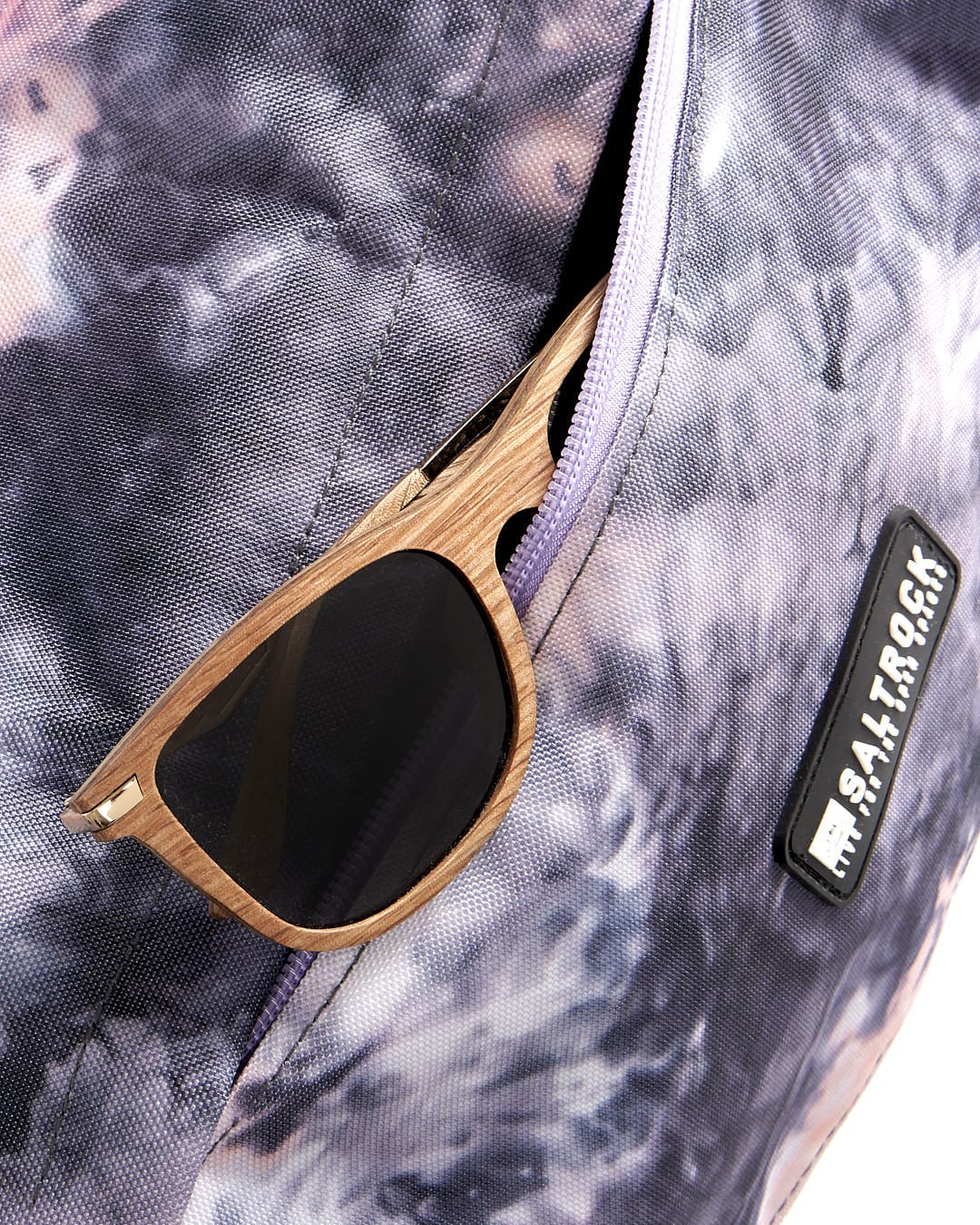 A Top Loader - Backpack - Pink/purple by Saltrock with sunglasses and sunglasses in it.