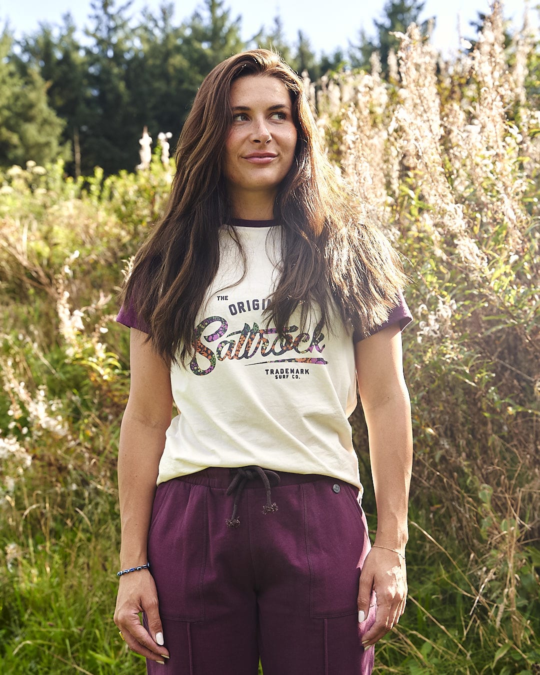 A woman wearing a Saltrock Trademark Floral - Womens Short Sleeve T-Shirt - Cream standing in a field.