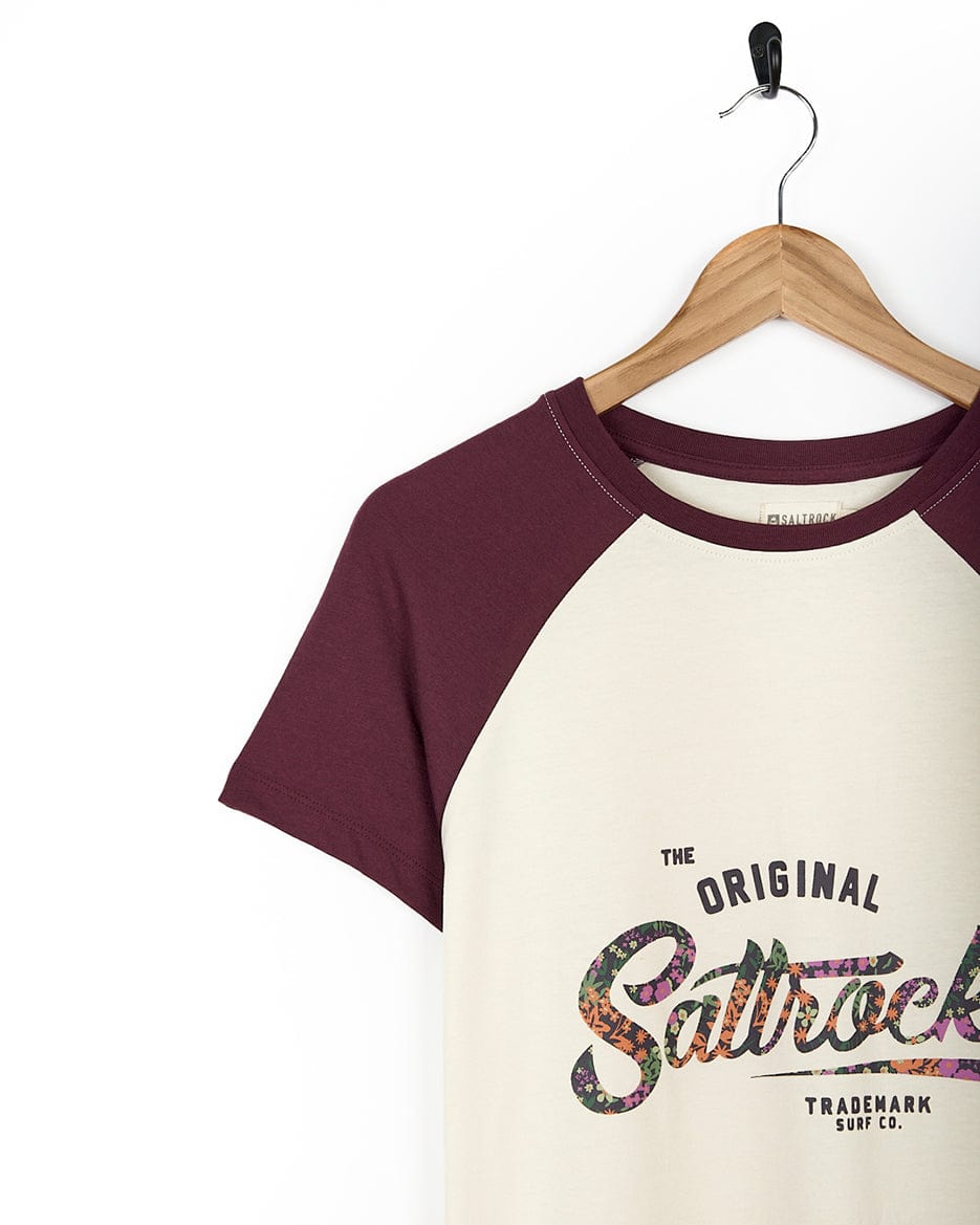 A maroon Trademark Floral - Womens Short Sleeve T-Shirt - Cream with Saltrock branding.