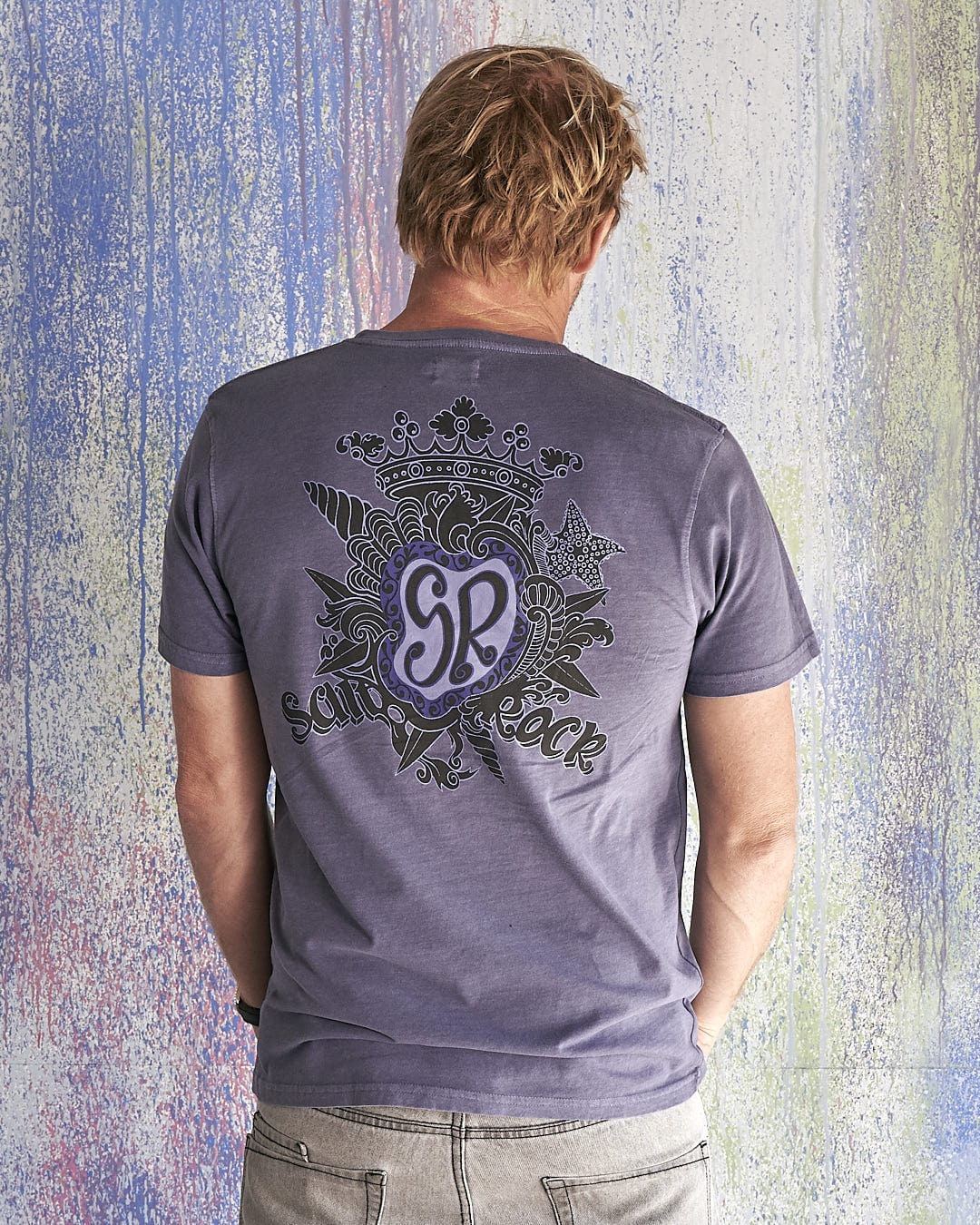 The back of a man wearing a Saltrock - Limited Edition 35 Years T-Shirt.