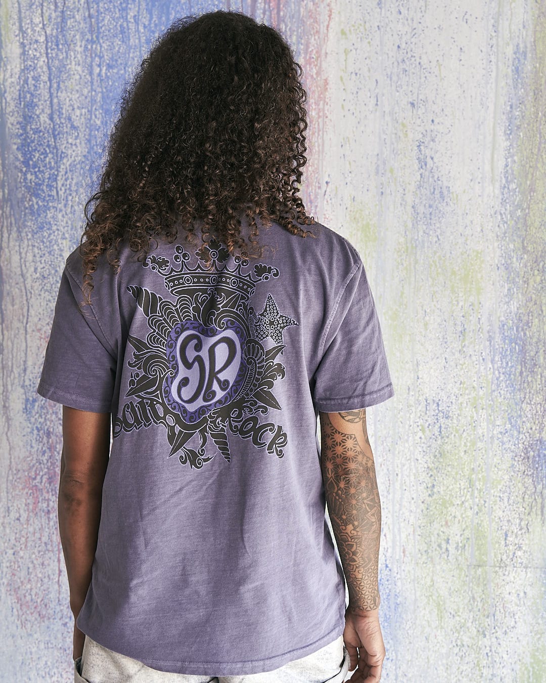 The back of a woman wearing a Saltrock - Limited Edition 35 Years T-Shirt.
