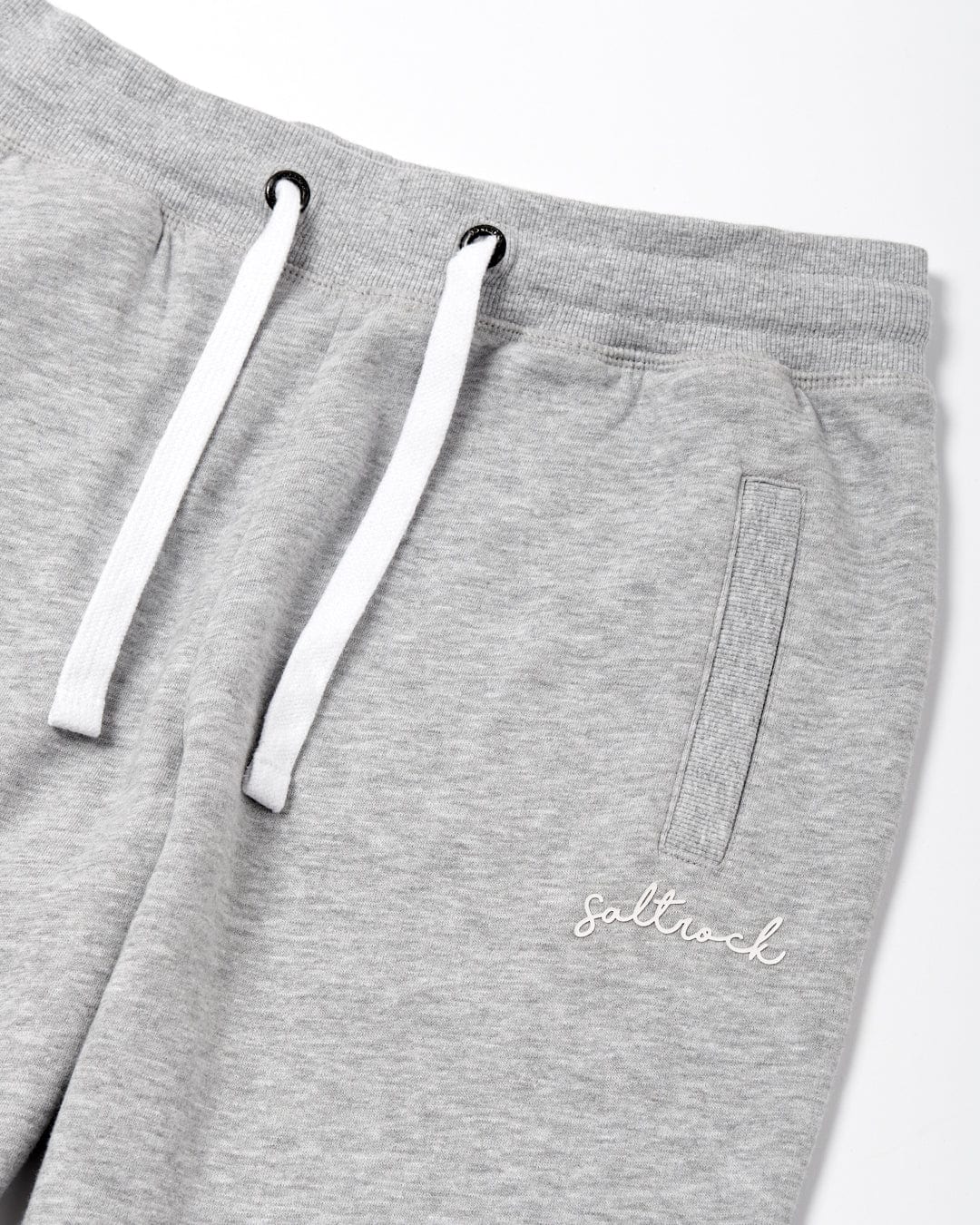 Saltrock Velator - Women's Jogger - Light Grey sweatpants with white drawstrings and a 'Saltrock' logo on the left thigh. These also feature an elasticated draw cord waist for a comfortable fit.