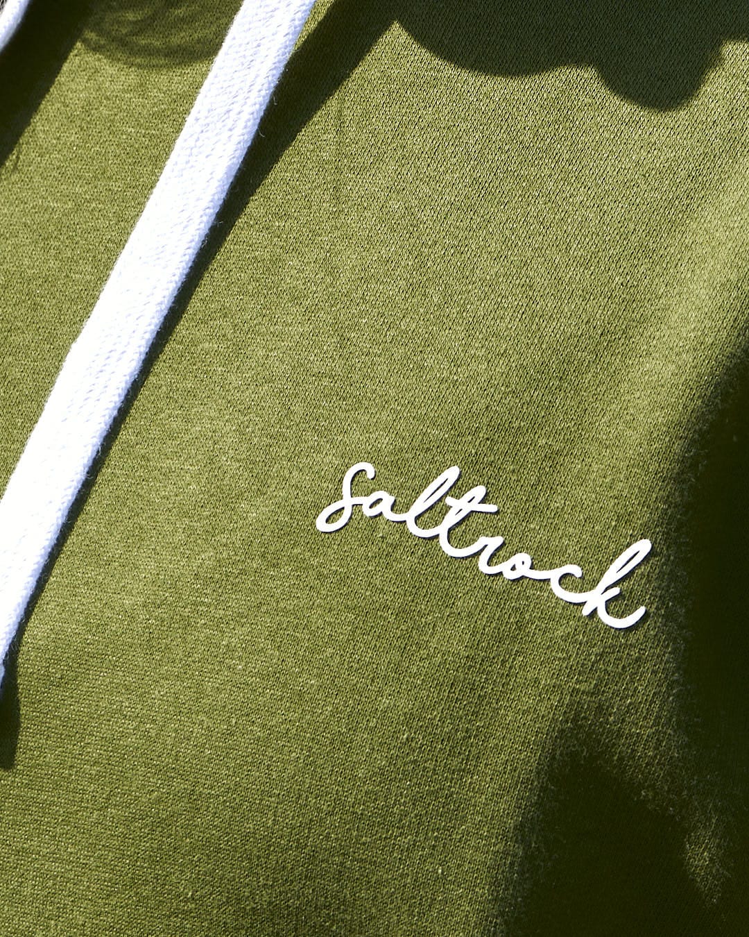A woman wearing a green Saltrock Velator - Womens Pop Hoodie - Green.