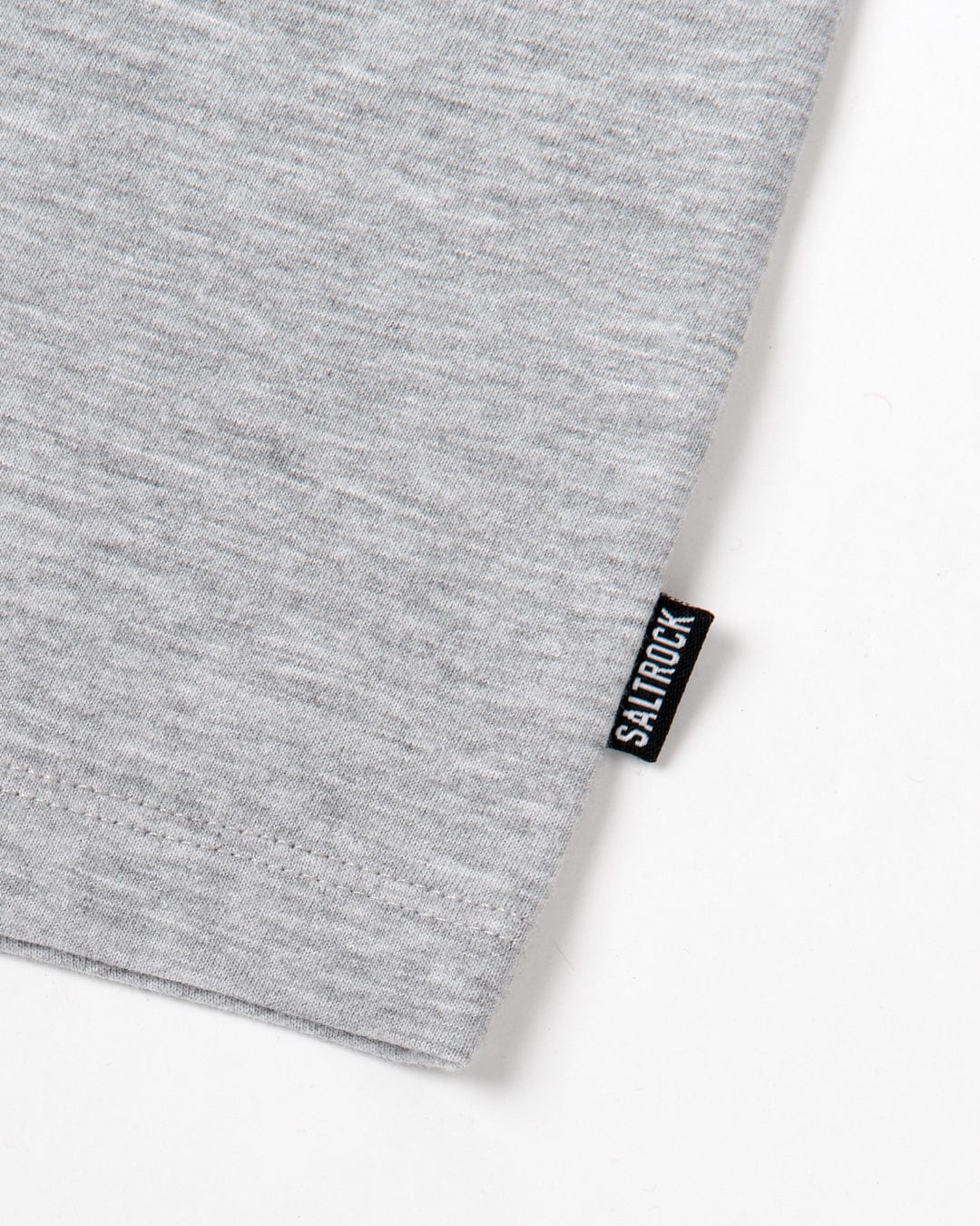 Close-up of a gray Velator - Womens Short Sleeve T-Shirt - Grey Marl with a black Saltrock tag stitched on the edge.