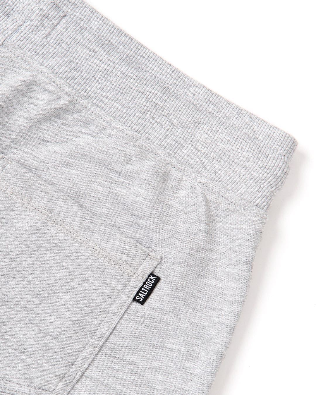 The back pocket of a Velator - Womens Sweat Short - Grey featuring a standard fit and Saltrock branding.