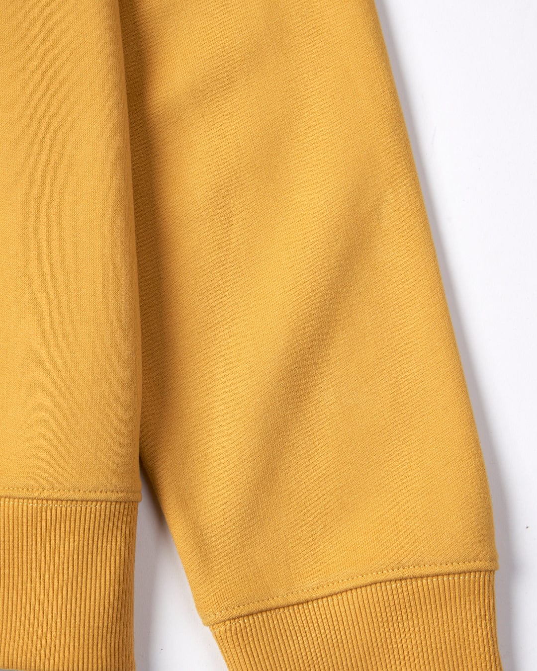 Close-up view of a Saltrock Velator - Womens Sweatshirt in Mustard Yellow with ribbed cuffs and a crew neckline on a white background.