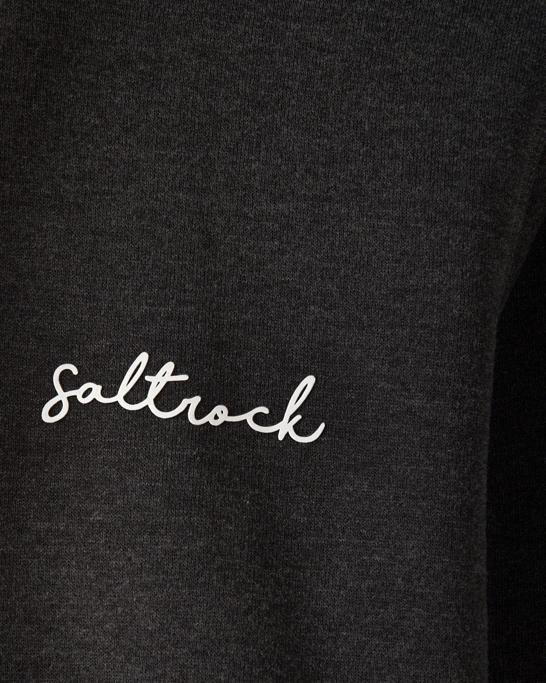 Close-up of the Saltrock Velator Women's Pop Hoodie in dark grey, made from soft cotton and recycled polyester, with "Saltrock" printed in white cursive text.