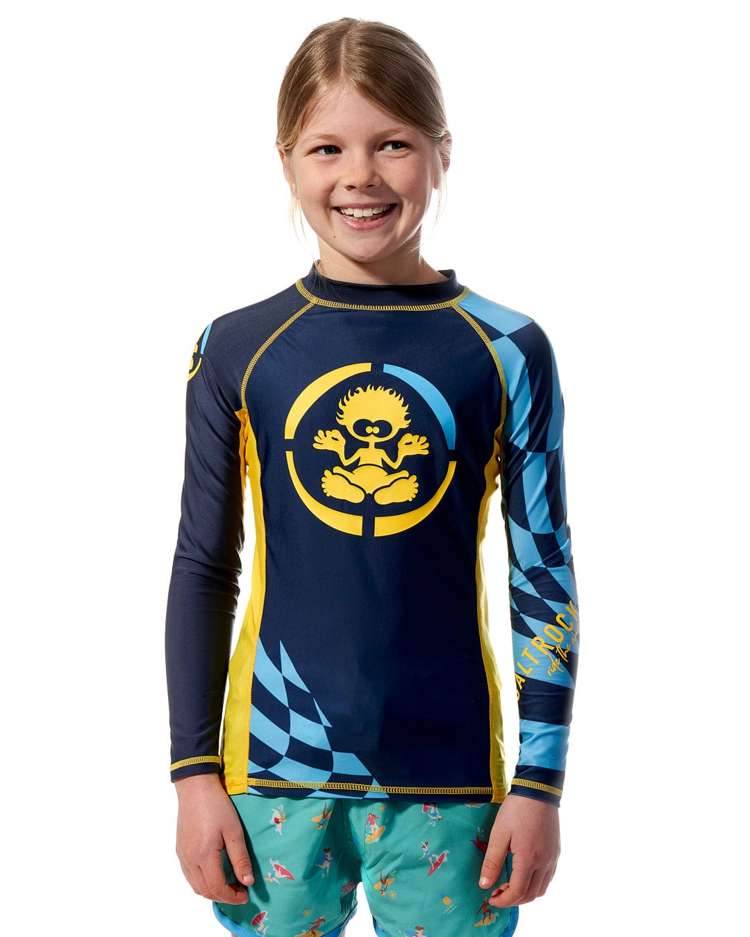 A young girl wearing a Saltrock Warp - Kids Long Sleeve Rash Vest - Blue.