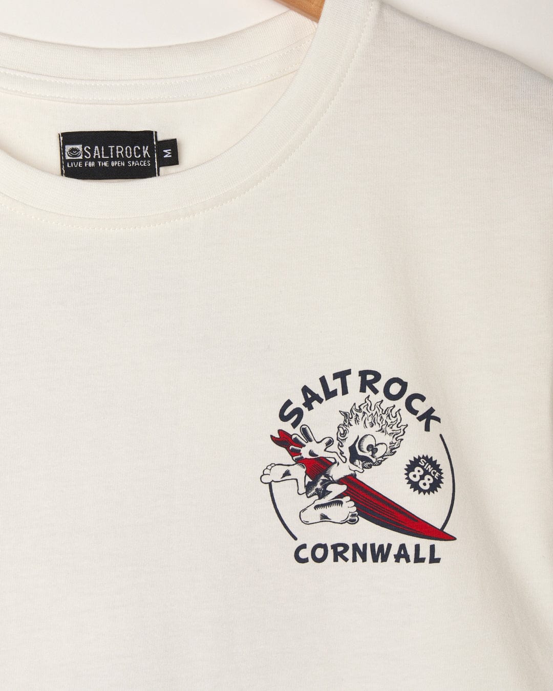 A white graphic t-shirt featuring the branding of Saltrock and the location name Cornwall. The Wave Rider Cornwall - Mens Short Sleeve - White by Saltrock.