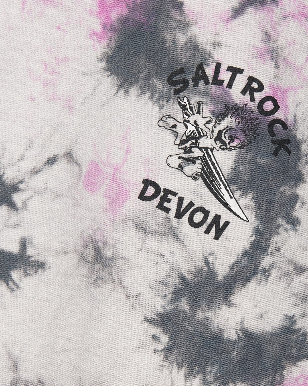 Close-up of a textile with a Wave Rider Devon - Kids Tie Dye Short Sleeve T-Shirt - Pink and the Saltrock branding logo.