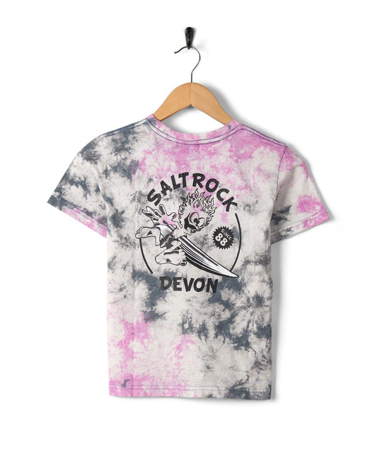 Wave Rider Devon - Kids Tie Dye Short Sleeve T-Shirt - Pink with Saltrock branding graphic print hanging on a wooden hanger against a white background.