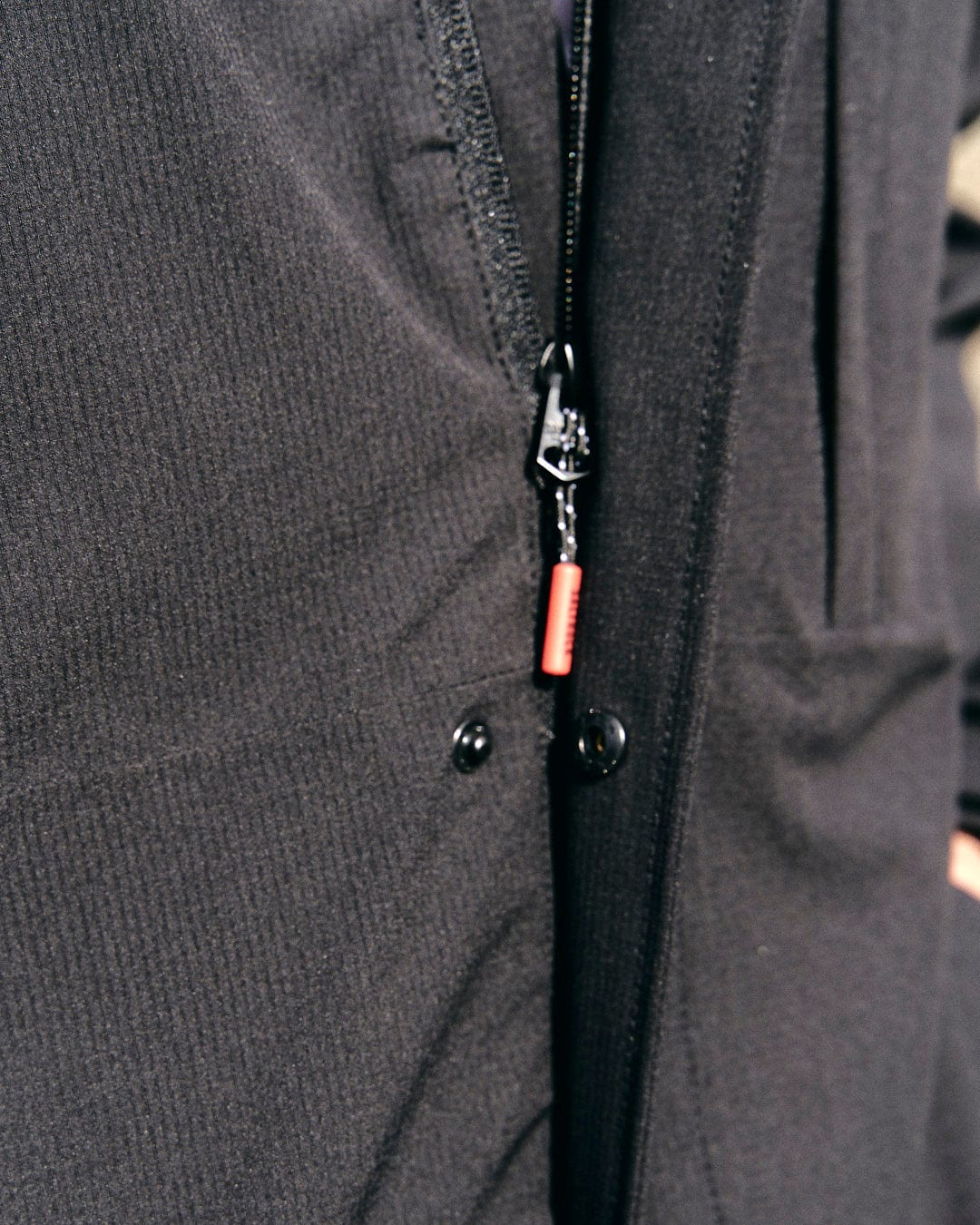 A close up of a Saltrock Whistler - Mens Hooded Jacket - Black with a zipper and waterproof feature.