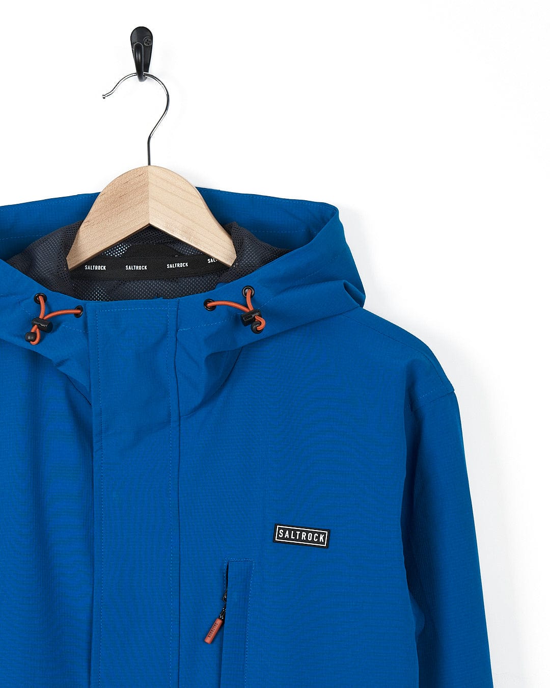 A Saltrock Whistler - Mens Hooded Jacket - Blue hanging on a hanger.