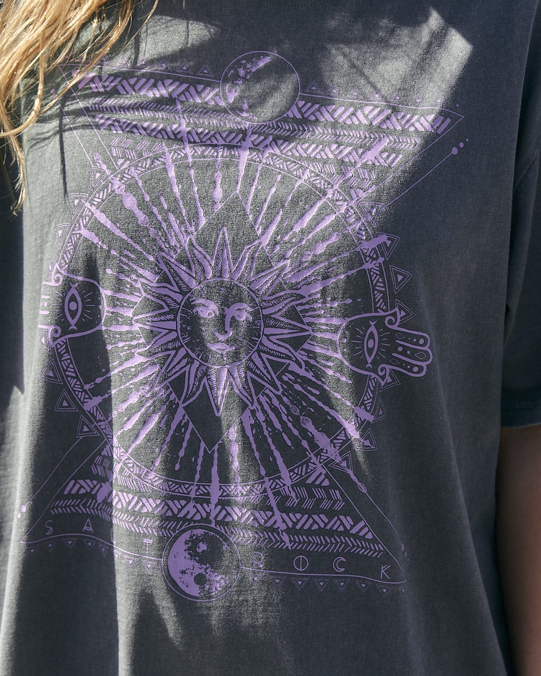 A woman wearing a purple Saltrock Winter Solstice - Womens Short Sleeve T-Shirt - Dark Green.