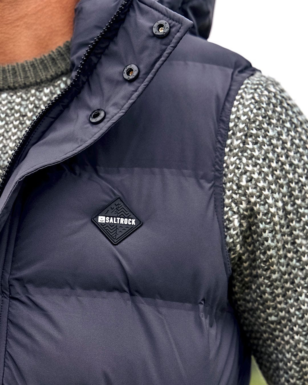 The back of a man wearing a Saltrock Xavier - Mens Padded Gilet - Dark Grey.